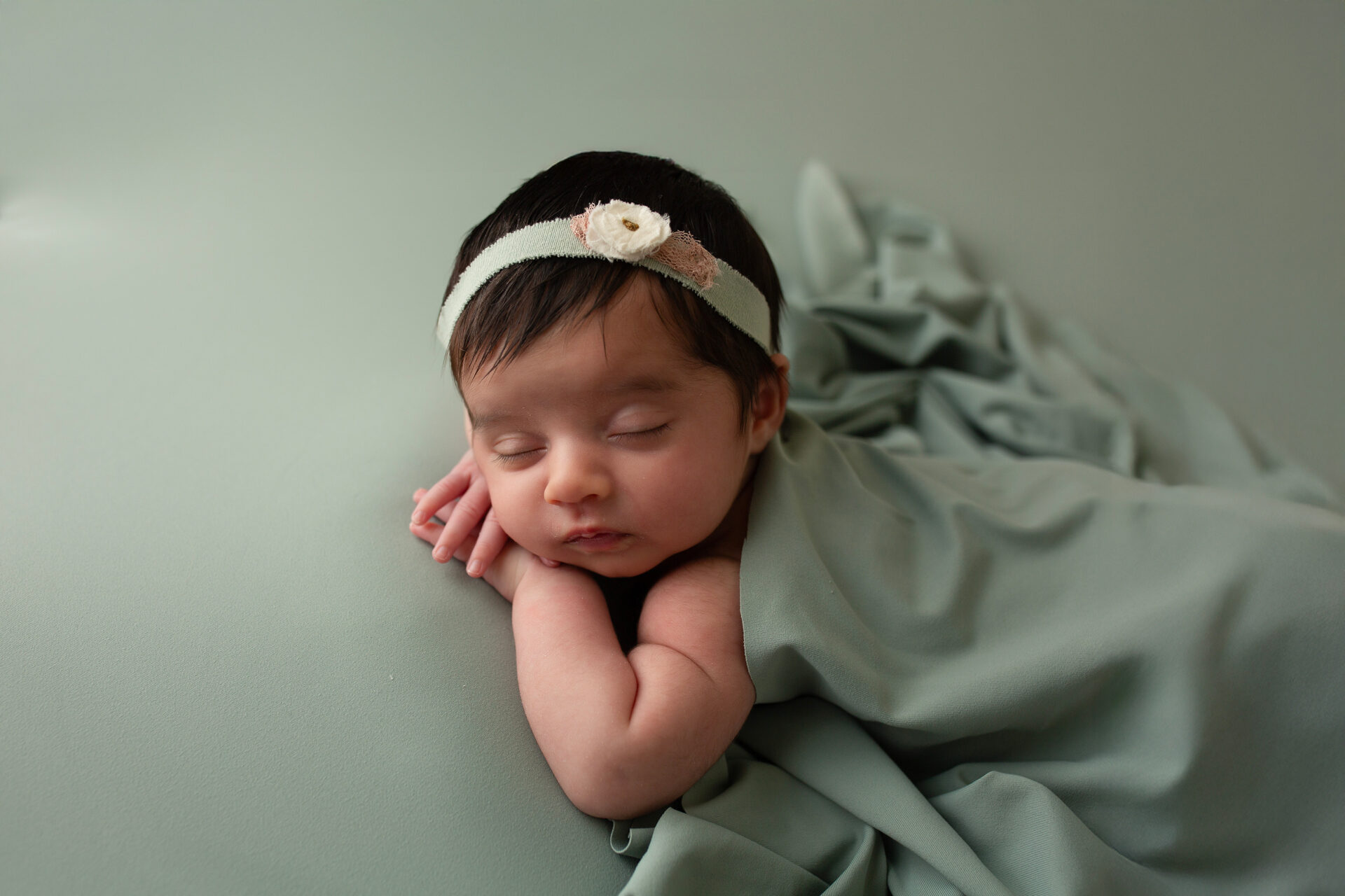 manteca baby photographer capturing peaceful newborn girl in simple studio setup