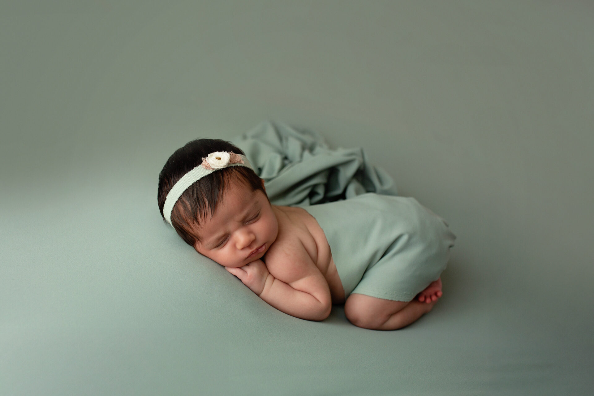newborn baby girl posed naturally in soft neutral tones by manteca newborn photographer