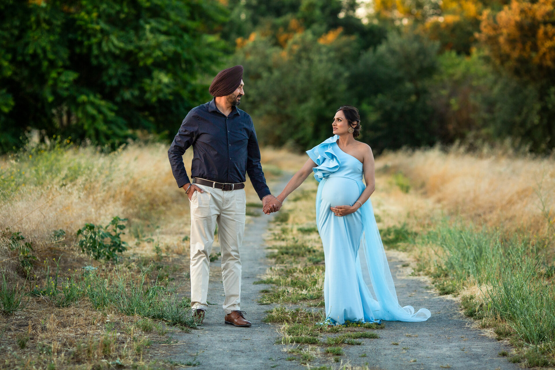 Expecting parents embracing during a Roseville maternity session.