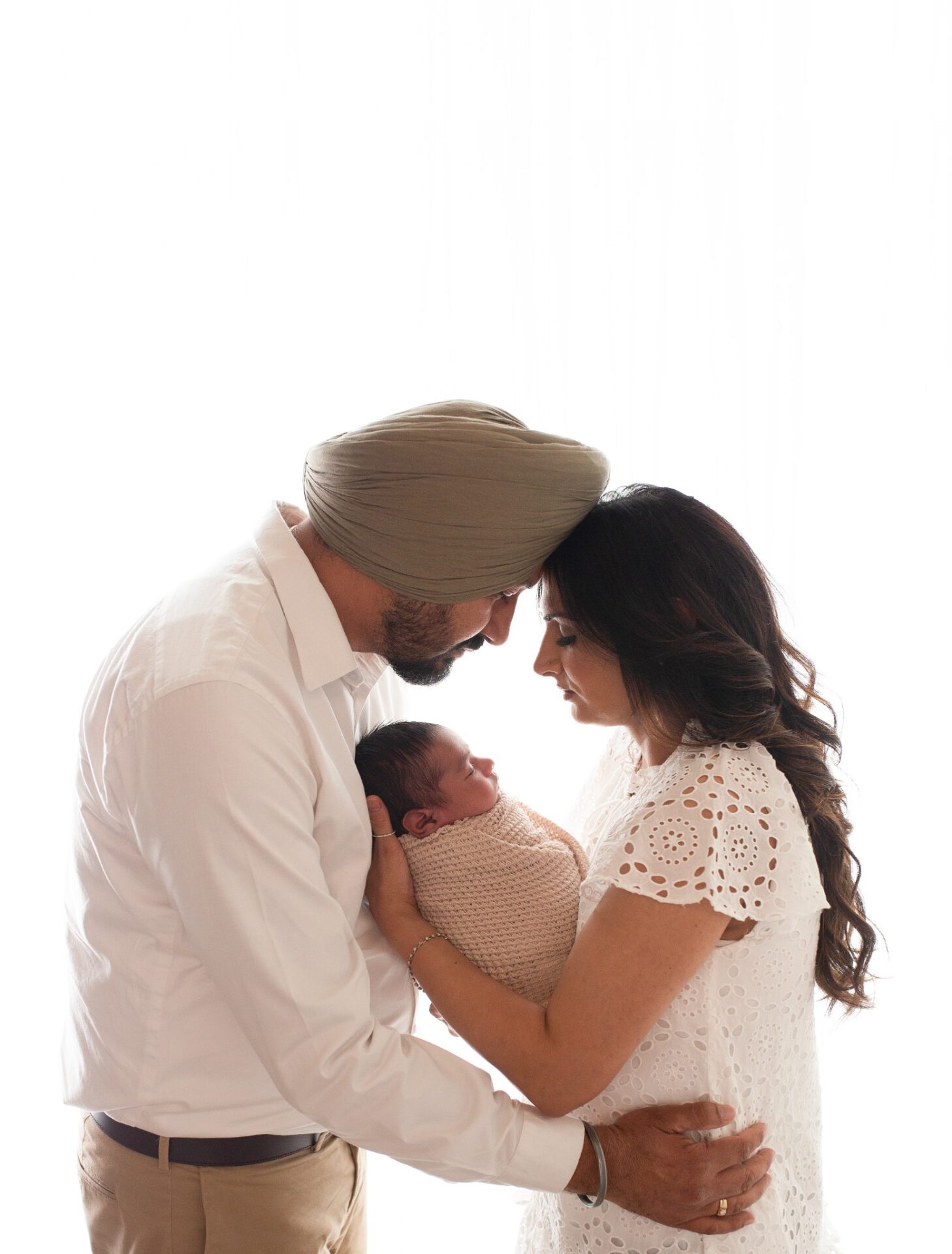 Parents holding their newborn close
